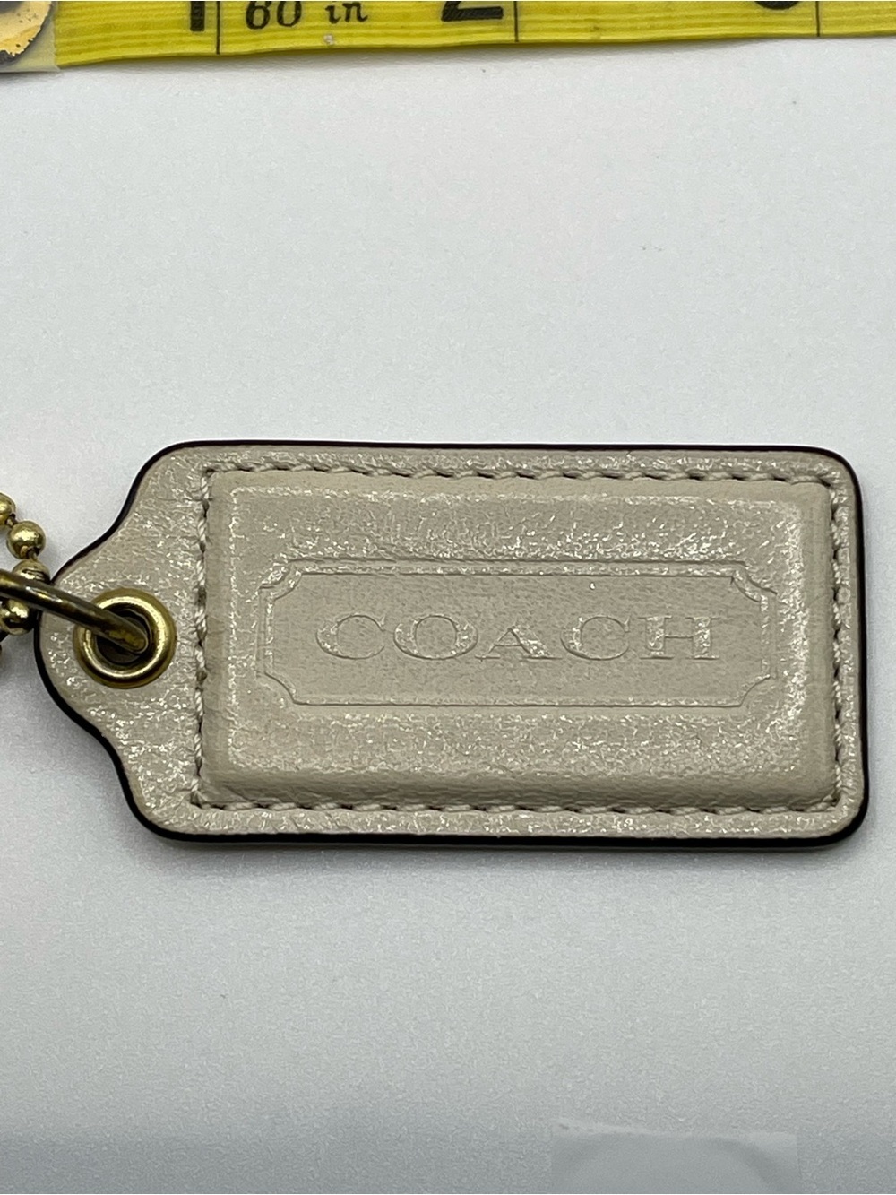 Coach Shimmering Cream Leather Hang Tag with Gold Chain